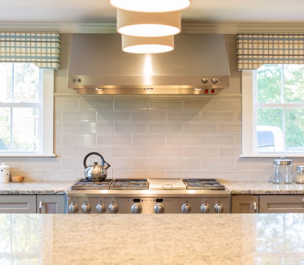 Image of bright kitchen with stove and windows